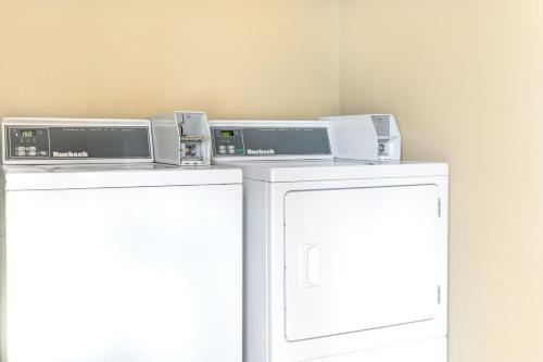 two white refrigerators sitting next to each other at Super 8 by Wyndham Ruston in Ruston