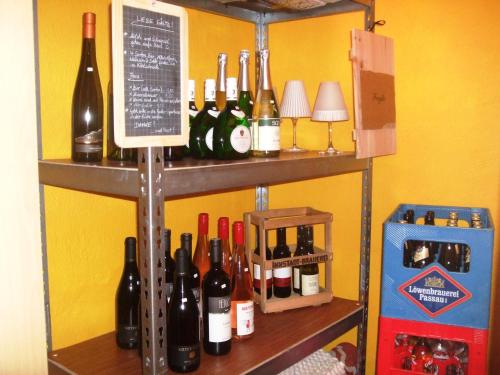 a shelf with many bottles of wine on it at Ferienwohnung Örtl 7 in Obernzell