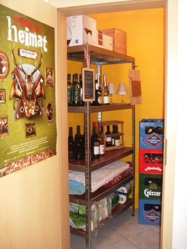 a room with a shelf with bottles of alcohol at Ferienwohnung Örtl 7 in Obernzell