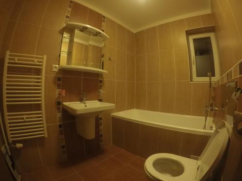 a bathroom with a sink and a toilet and a tub at Beška in Bešeňová