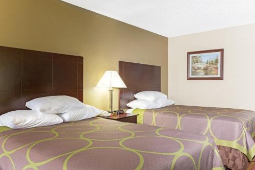 two beds in a hotel room next to each other at Super 8 by Wyndham Ruston in Ruston