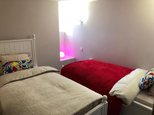 a room with two beds and a bright window at Les Maisons du Périgord in Terrasson-Lavilledieu