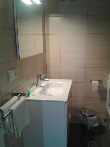 a bathroom with a sink and a mirror at Las Américas - Mares in Torre del Mar