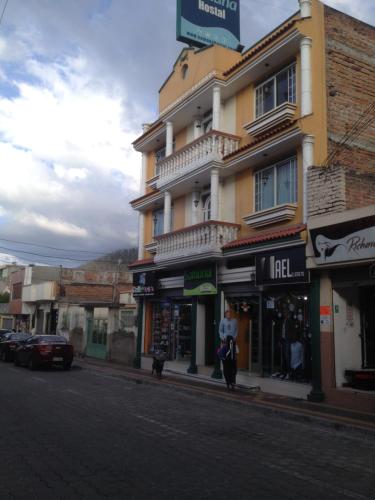 a building on the side of a city street at Samana Hostal in Otavalo