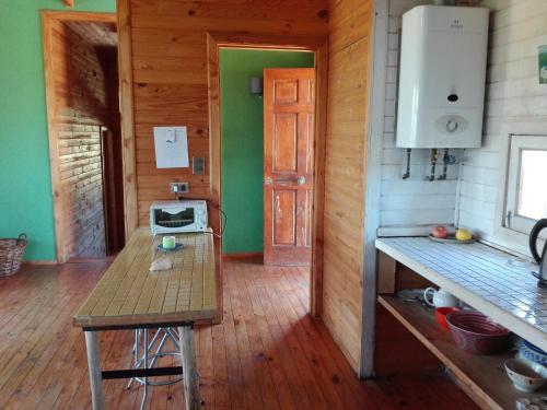 a kitchen with a table and a stove in a room at Casa San Juan in San Juan