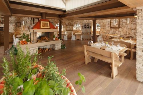 a dining room with a table and a fireplace at Istrian Villas Plava Laguna in Umag