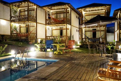 a resort with a swimming pool and a building at Pousada Meu Talento in Alto Paraíso de Goiás