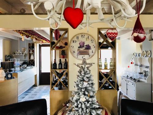 a christmas tree in a wine shop with a clock at Palascìa Wellness Relais in Otranto