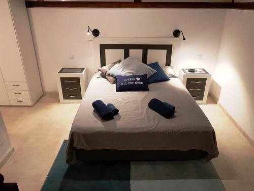 a bedroom with a large bed with two night stands at Las Arecas Loft in Playa Blanca