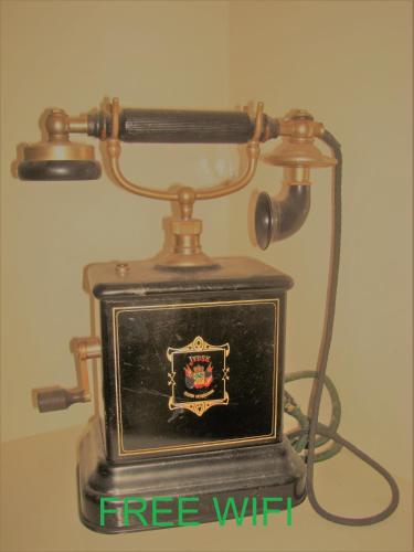 an old telephone with a free wifi sign on it at Boutiquehotel Sycamore - Protected City View - 950m from Central Station in Eindhoven