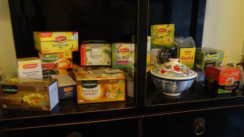 a cabinet filled with boxes of food and a vase at Boutiquehotel Sycamore - Protected City View - 950m from Central Station in Eindhoven