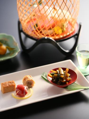 a white plate with food on a table at Shosenkaku in Nagano