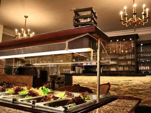 a buffet in a restaurant with plates of food at Hotel Castello Borghese in Senningerberg