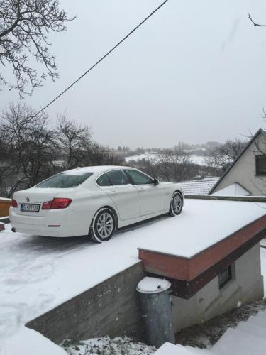 a white car parked on top of a snow covered roof at Alena Hutarova -Chalupa Bzince pod Javorinou in Dolní Bzince