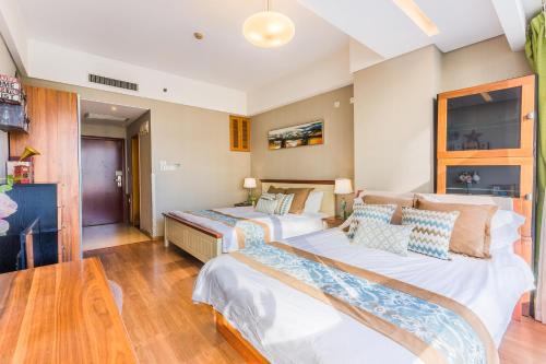 a bedroom with two beds and a table at Westlake 7 Service Apartment in Hangzhou