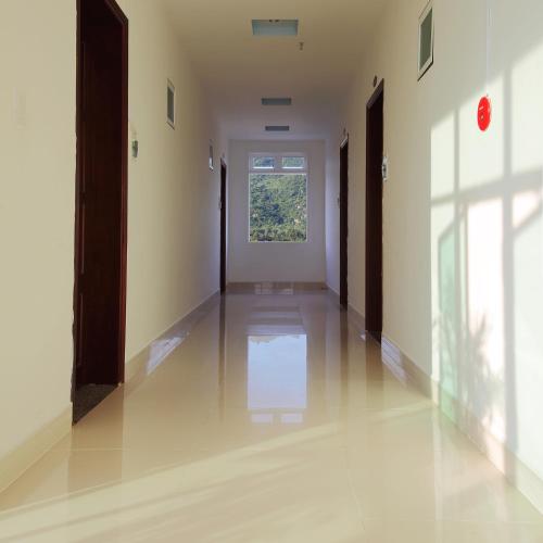 an empty hallway with a window in a building at Gold Stars Hotel in Long Hai