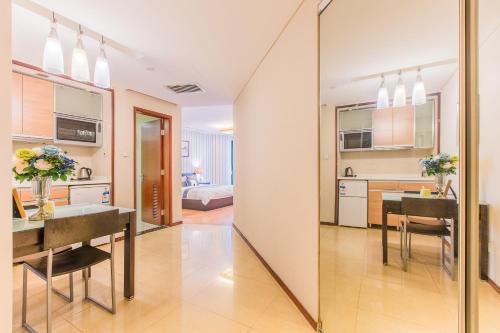 a kitchen and dining room with a large mirror at Westlake 7 Service Apartment in Hangzhou