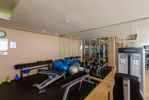 a gym with several treadmills and weights at Mandarava Resort and Spa, Karon Beach in Karon Beach