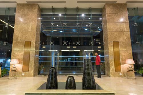 a man standing in front of a lobby at Classic Grande,a Member of Radisson in Imphal