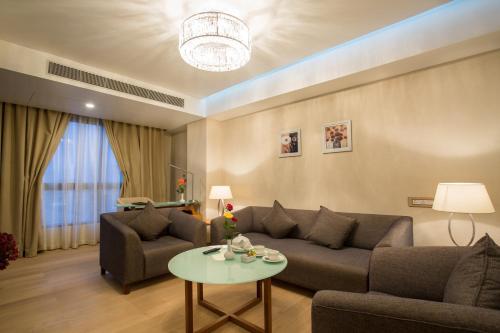 a living room with a couch and a table at Classic Grande,a Member of Radisson in Imphal
