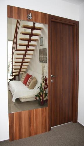 a room with a spiral staircase with a bed at Art Hotel Podebrady in Poděbrady