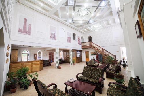 a large lobby with couches and chairs in a building at Siyavush in Bukhara