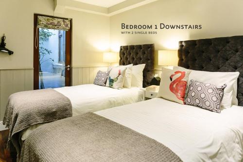 a hotel room with two beds and a sign on the wall at Cosy Home; Sleeps 10/11. City 15 minutes’ walk in Dublin