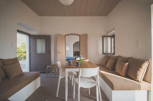 a living room with a couch and a table at Donusa Beach House - Etheras properties in Diakofti