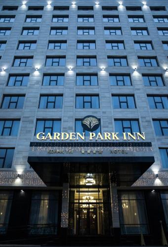 a building with a sign that reads garden park inn at Garden Park Inn in Almaty