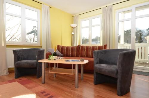 オストゼーバート・ゼリンにあるVilla Seerose - Appartement 04のリビングルーム(ソファ、椅子2脚、テーブル付)