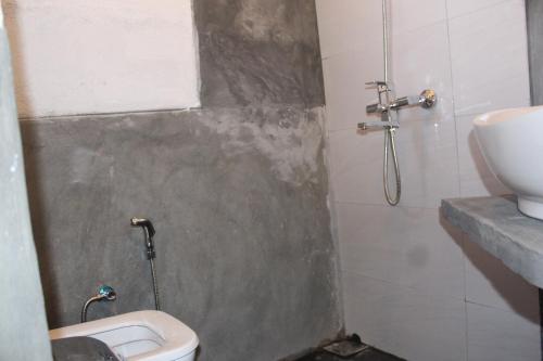 a bathroom with a shower with a toilet and a sink at Natures Bliss Holidays in Ja-Ela