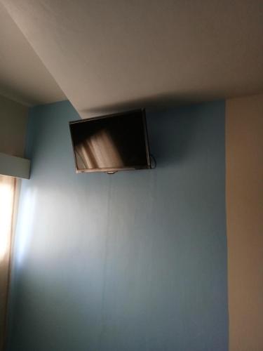 a flat screen tv on the ceiling of a room at Anthurium Inn in Mactan