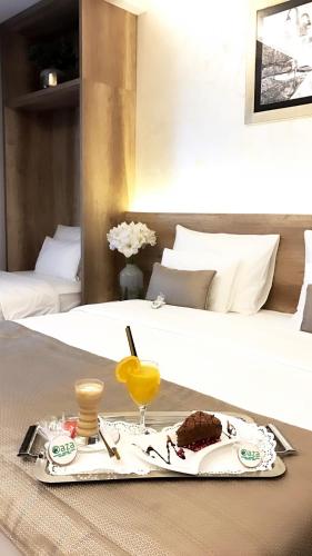 a tray with a plate of food on a bed at Villas and apartments Oaza in Sarajevo
