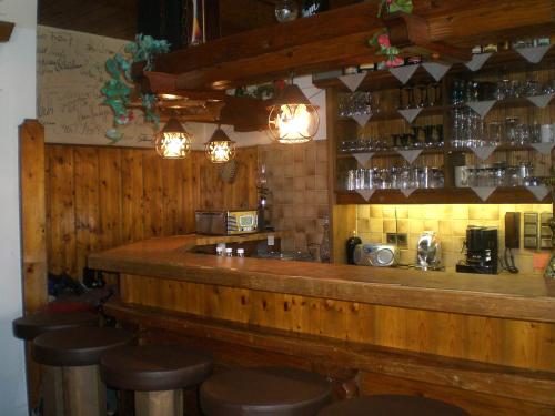 a bar in a restaurant with stools in front of it at Hiasl Stubn in Donnersbach