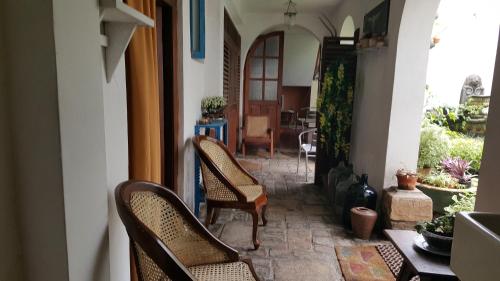 Beatrice House Galle Fort في غالي: ممر به كراسي وطاولة في منزل