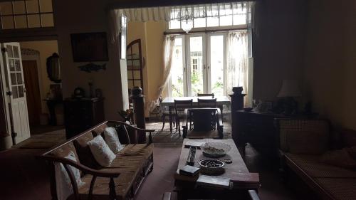 a living room with a couch and a table at Beatrice House Galle Fort - Homestay in Galle
