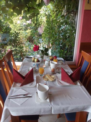 a table with a white table cloth on it at Pension Jana Tatrovice in Tatrovice