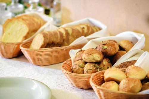 a table topped with baskets of bread and pastries at 7 Days City Hotel in Dnipro
