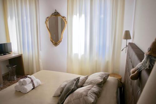 a bedroom with a bed with a mirror on the wall at B&B Al Pozzo di Luce in Venice