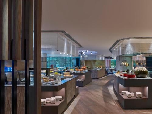 a restaurant with a bunch of food on display at New World Millennium Hong Kong Hotel in Hong Kong
