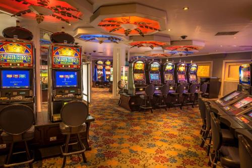 a casino with many slot machines in a room at Peermont Walmont at Mmabatho Palms in Mahikeng