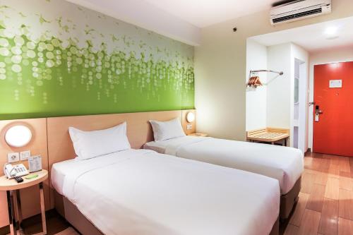 Zest Harbour Bay Batam by Swiss-Belhotel International tesisinde bir odada yatak veya yataklar
