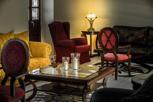 a living room with chairs and a coffee table at Mystras Grand Palace Resort & Spa in Mystras