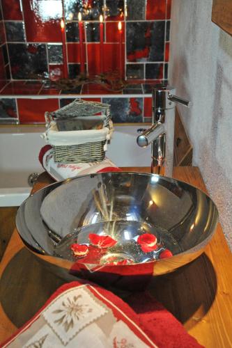 a bathroom sink with a bowl on top of it at Affittacamere Petit Coeur in Champoluc