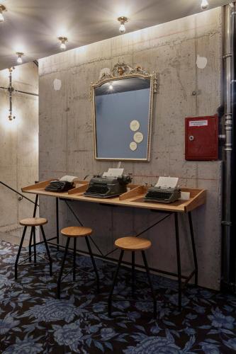 a desk with a computer on top of it at 25hours Hotel The Royal Bavarian in Munich