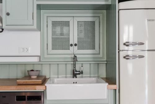 a kitchen with a sink and a white refrigerator at Jasmine Holiday Villa in Episkopí- Rethimno