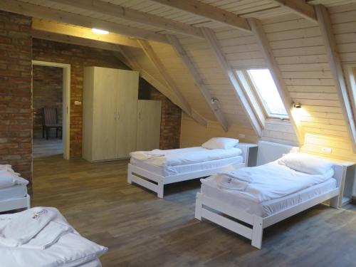 a room with three beds in a attic at Motel Klara in Sobótka