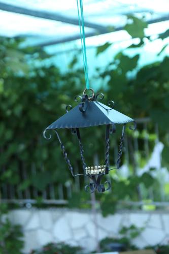 a small black umbrella hanging from a string at Apartments Vila ViDa Orebić in Orebić