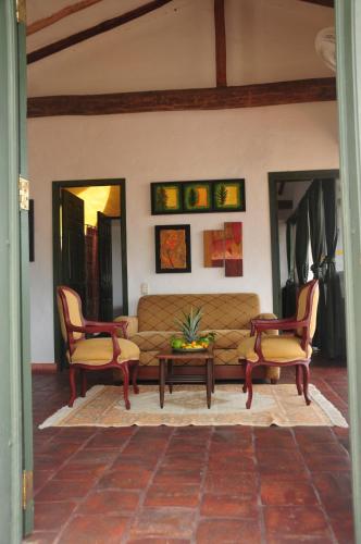 a living room with a couch and two chairs at Hotel Mision Santa Barbara RNT 4799 in Barichara
