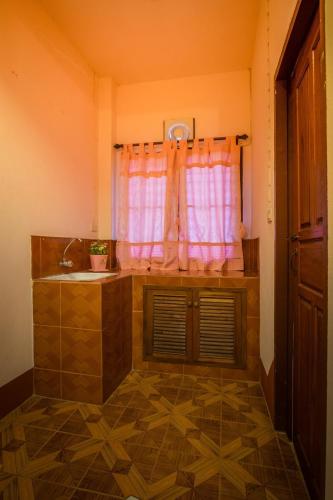 a bathroom with a sink and a window at Happy in Pai in Pai